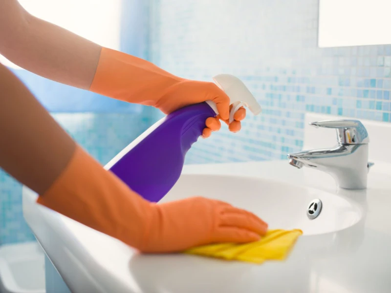 Uniformed Sparkline cleaner at work in a Brixton flat